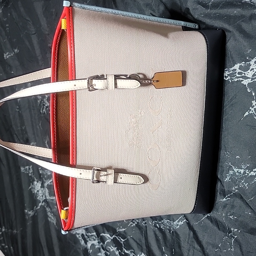 Never worn without tags Coach mini hand bag leather bottom cloth top